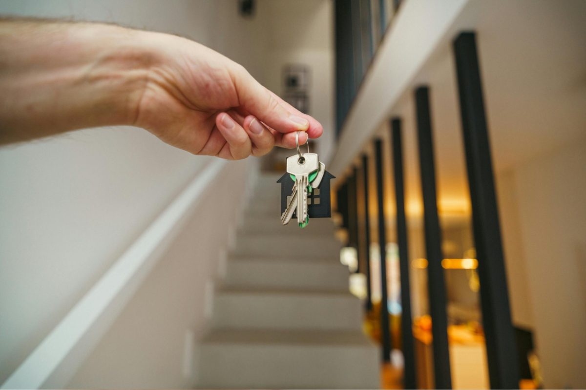 A young professional receiving apartment keys in a Tokyo neighborhood with strong rental yields