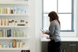 A beauty advisor guides a woman through a double cleanse routine at a Tokyo department store counter