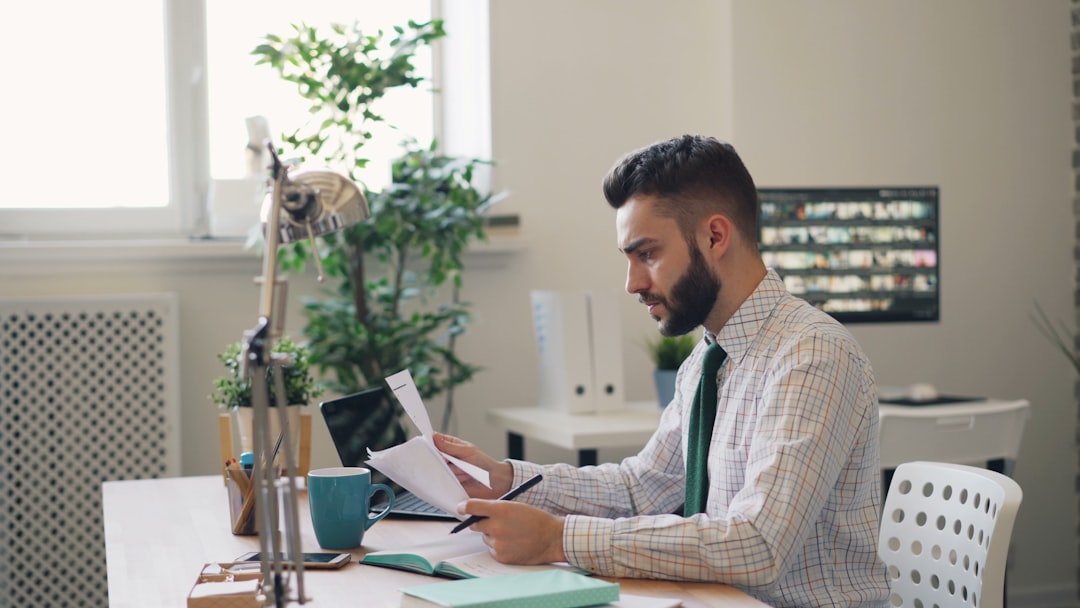 A professional prepares membership documents to lease a co-working desk in Shibuya without a Japanese guarantor