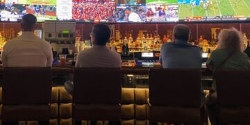 A packed crowd of fans cheering at one of Tokyo's sports bars during a World Cup match