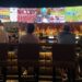 A packed crowd of fans cheering at one of Tokyo's sports bars during a World Cup match