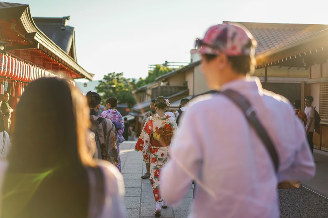 A family pauses at a bamboo display to write tanzaku wishes during Tanabata Tokyo at a local shrine