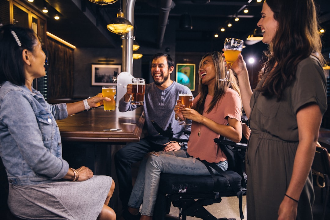 A group of friends raising glasses together at Tokyo sports bars on a late-night World Cup kick-off