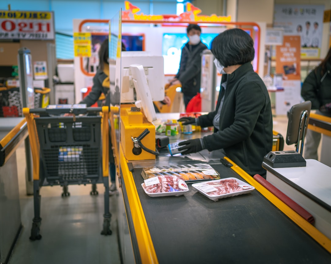 A customer completing a purchase at a Tokyo counter, illustrating the daily reach of konbini culture across the city