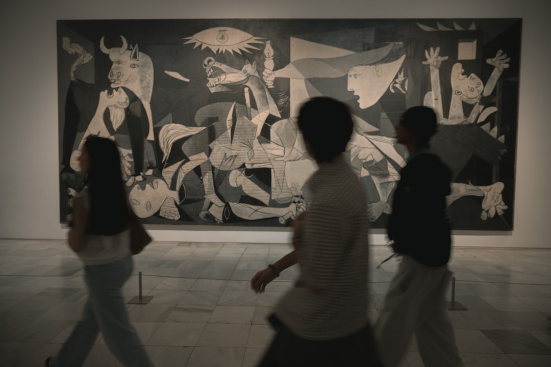 A man looking closely at a Picasso exhibition artwork surrounded by vibrant design details in Roppongi Tokyo