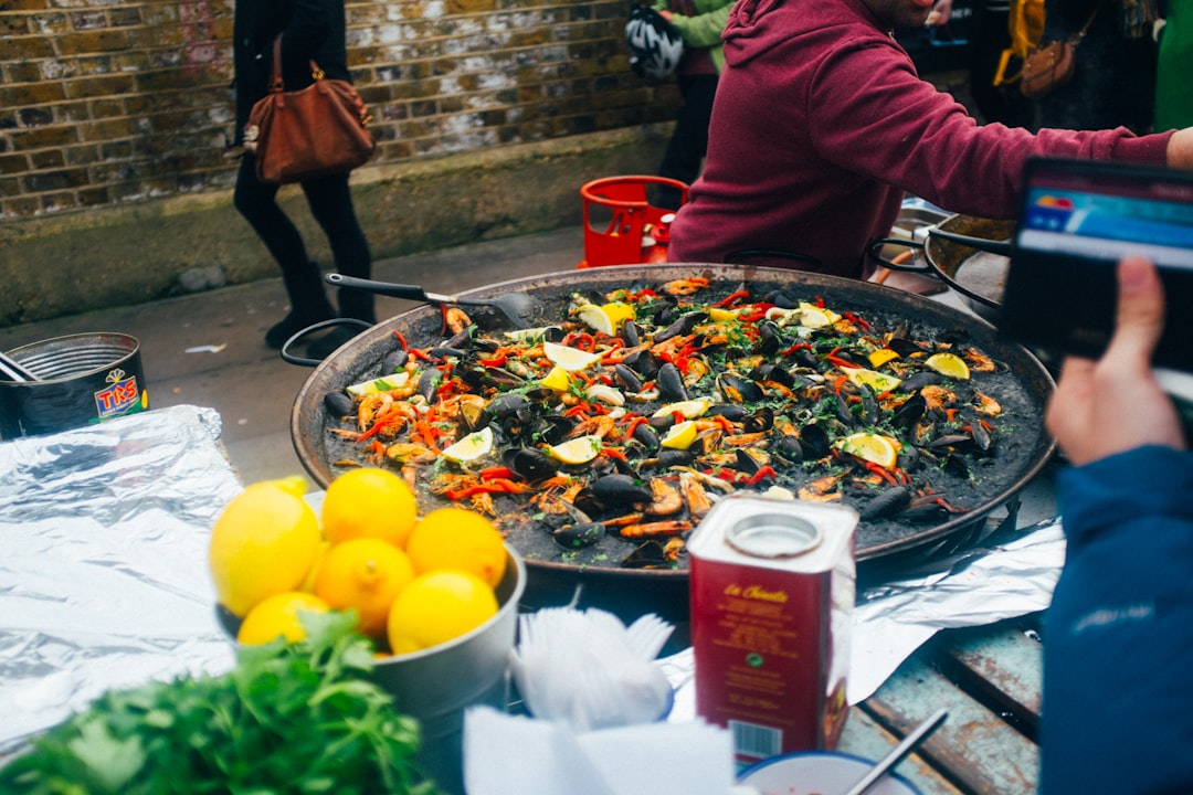 A man tastes freshly cooked paella at an outdoor food festivals event in central Tokyo.