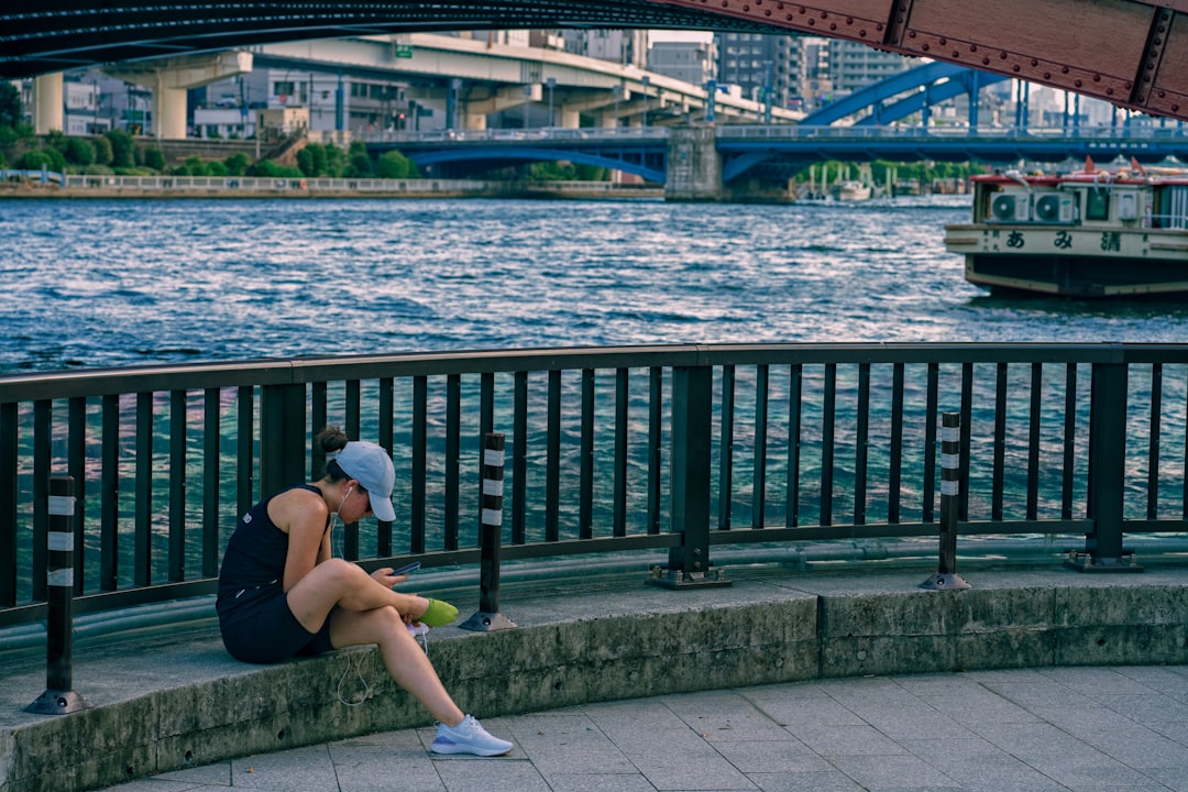 Runners stretching together after a Tokyo running club session in a central city park