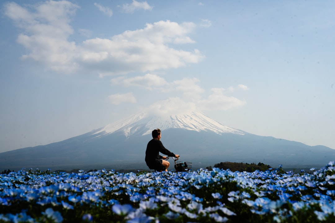 A couple enjoys a nemophila day trip among vast blue flower fields at Hitachi Seaside Park in spring