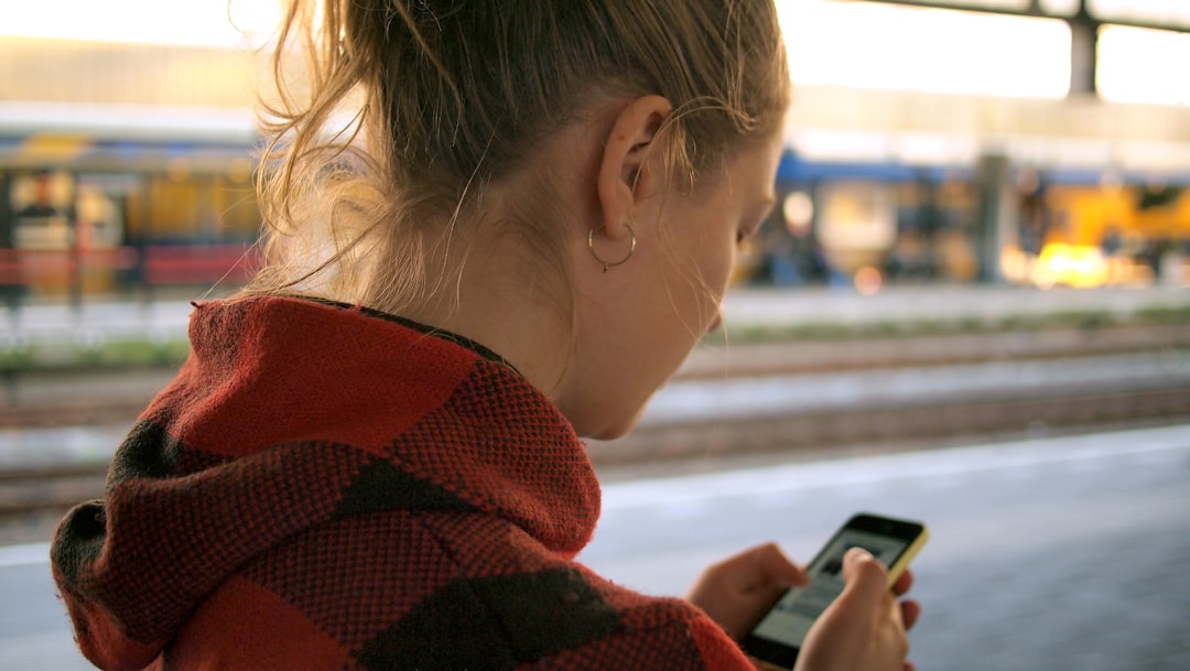A woman in Tokyo checking a ward recycling app on her phone to confirm trash sorting categories before collection day
