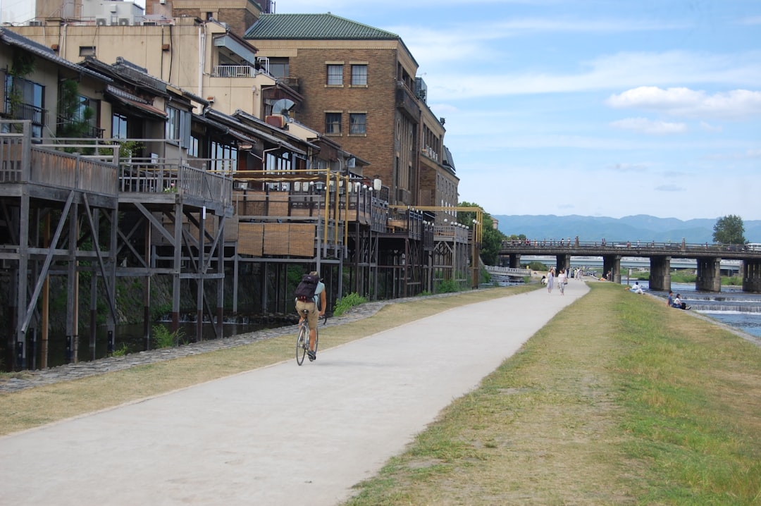 A woman jogging alone along a scenic riverside route popular with Tokyo running club members