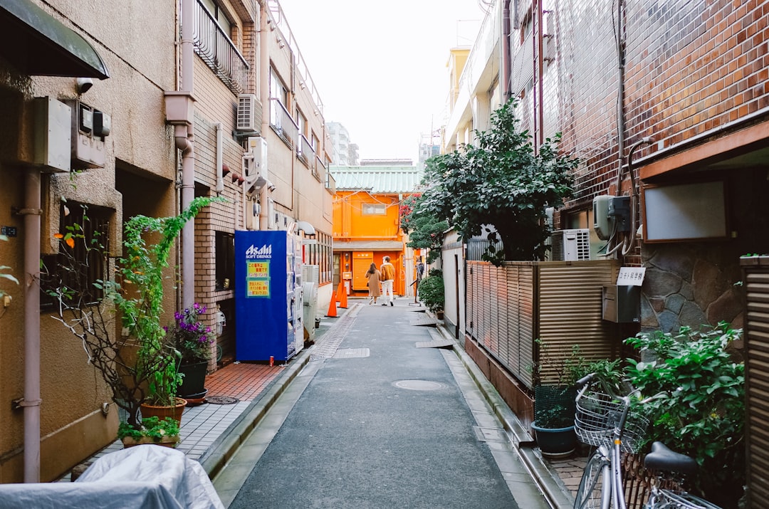 A woman walking through a Tokyo neighborhood known for competitive rental yields and strong tenant demand