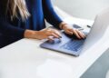 woman-working-laptop-unsplash - TOKYOwebzine A foreign professional secures a co-working desk in a modern Shibuya shared office space
