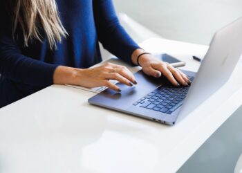 A foreign professional secures a co-working desk in a modern Shibuya shared office space