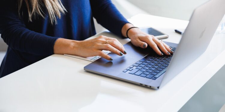 woman-working-laptop-unsplash - TOKYOwebzine A foreign professional secures a co-working desk in a modern Shibuya shared office space