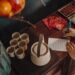 woman-writing-wish-paper-bamboo-unsplash - TOKYOwebzine A woman writes her Tanabata Tokyo wish on a colorful tanzaku strip at a bamboo display during the Star Festival