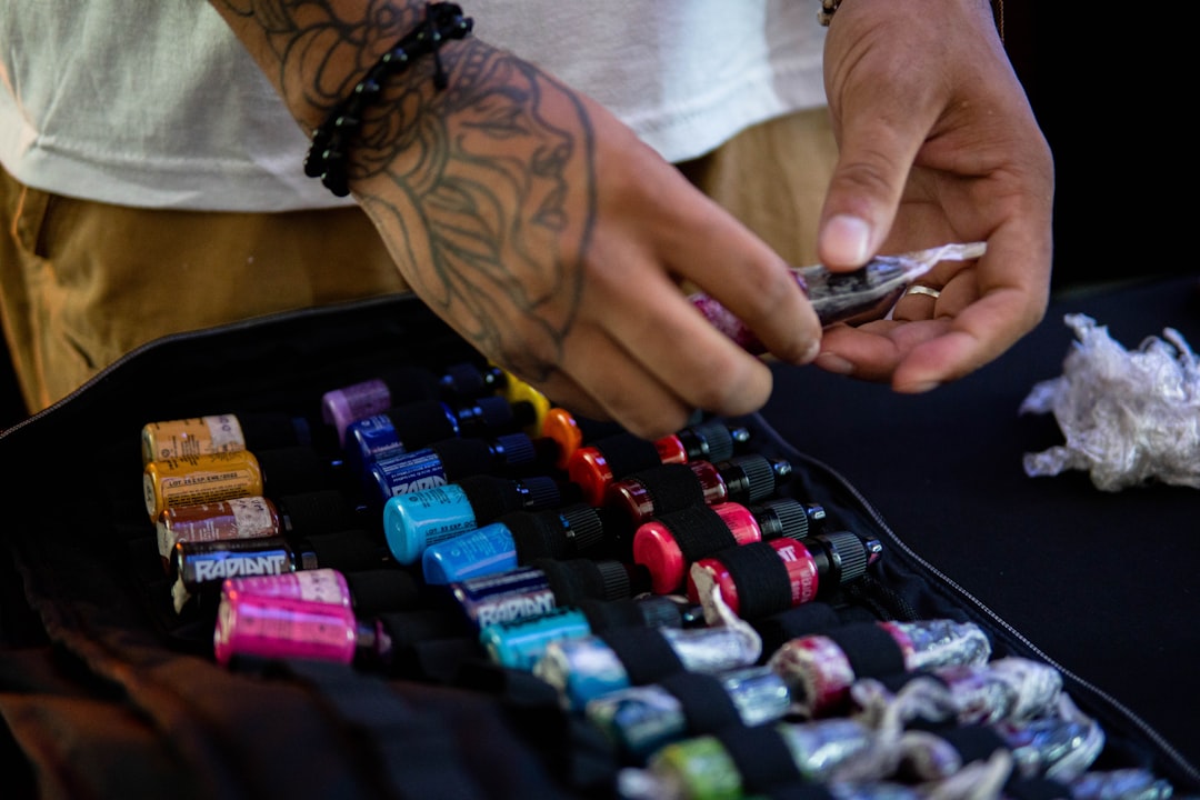 A man examining glass jars of pigment at a Tokyo art supplies specialist store in Tennozu Isle