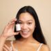 asiatic-woman-skincare-unsplash - TOKYOwebzine A woman applying lightweight serum as part of her humid skin care morning routine in Tokyo