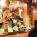 bartender-pouring-whiskey-unsplash - TOKYOwebzine A hotel bartender presents a curated Japanese whisky flight on a dark wood counter in Tokyo
