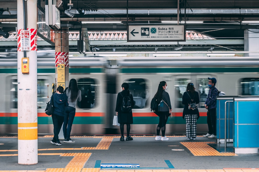 Commuters moving through a busy Tokyo underground malls corridor connected to a major train station