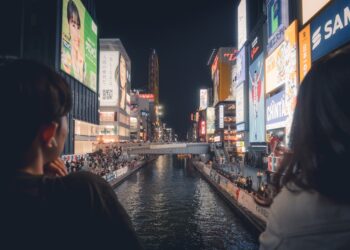 Spectators in yukata watching the hanabi festival over the Sumida River in Tokyo at night