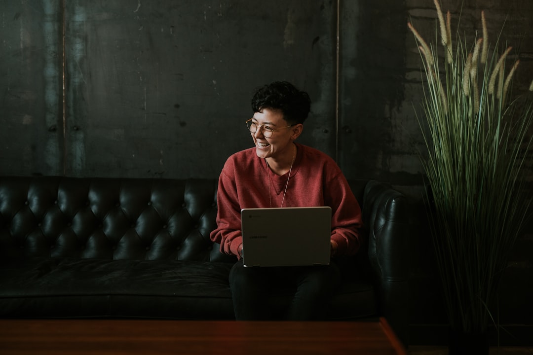 A foreign founder researching Japan trademark requirements on a laptop with a Tokyo skyline in the background