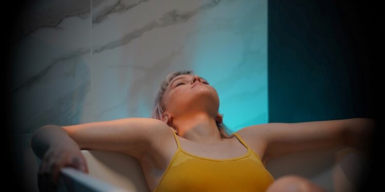 float-therapy-pod-unsplash - TOKYOwebzine A woman in a float therapy pod at a Tokyo wellness studio, preparing for a session of sensory rest.