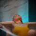 float-therapy-pod-unsplash - TOKYOwebzine A woman in a float therapy pod at a Tokyo wellness studio, preparing for a session of sensory rest.