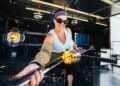 A woman works with molten glass during workshop