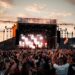 idol-festival-crowd-unsplash - TOKYOwebzine A performer on stage at Tokyo Idol Festival with a large crowd of fans cheering in the Odaiba waterfront venue
