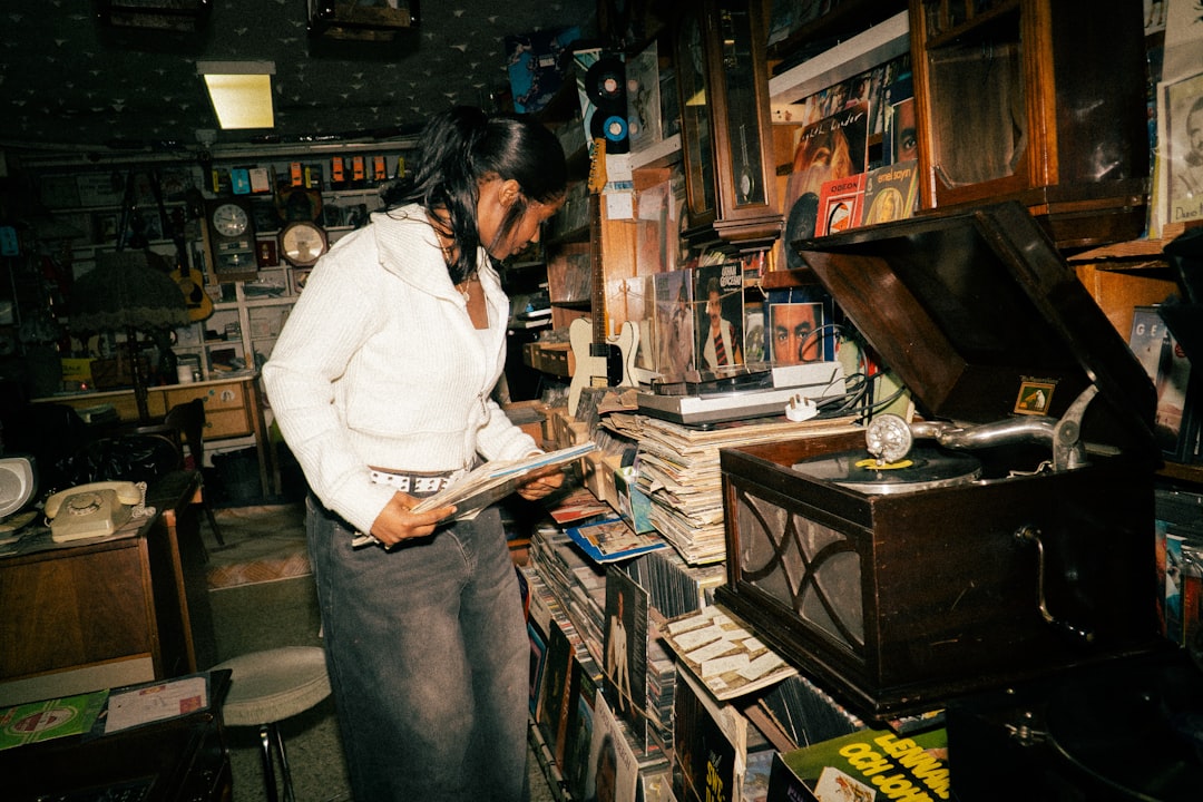A girl selects a record at a dimly lit Tokyo café, reflecting the focused atmosphere of kissa culture