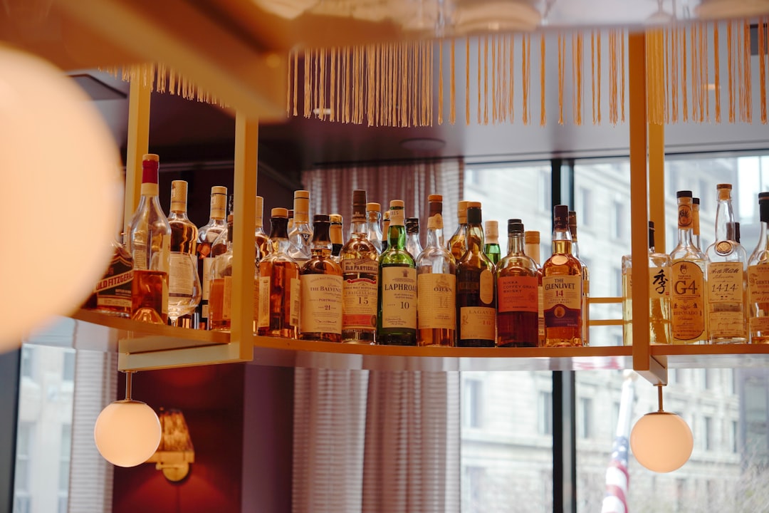 A sommelier selects a rare Japanese whisky bottle for a tasting flight at a Tokyo hotel bar