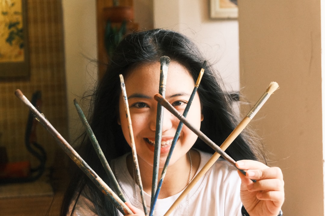 An artist carefully selecting brushes at a Tokyo art supplies store in the Okachimachi district
