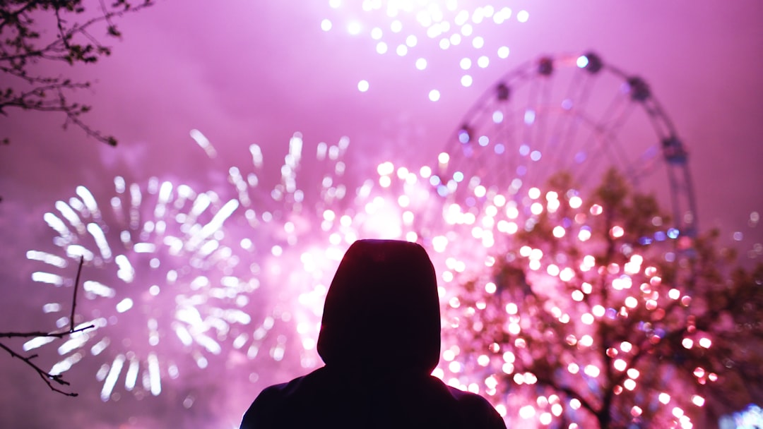 A visitor relaxing on the grass at one of Tokyo's open-air hanabi spots during the summer festival season
