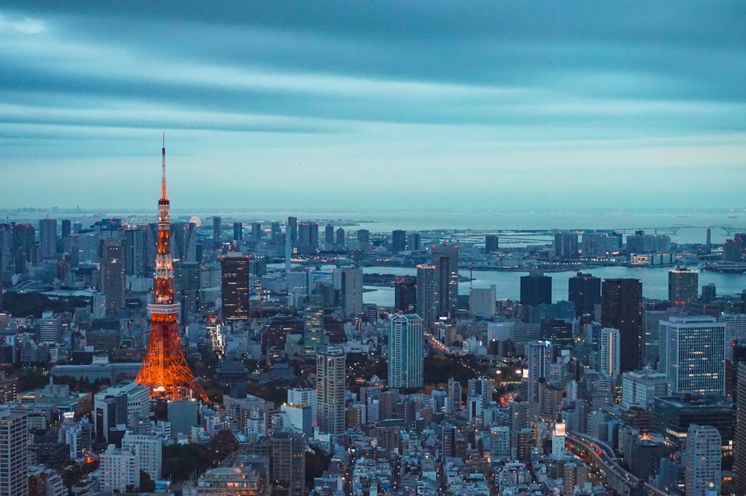 International entrepreneurs networking at a Tokyo startup coworking space, connecting with local innovators