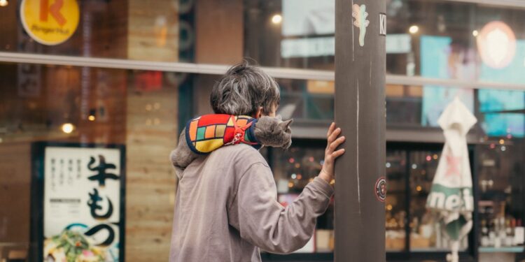 woman-adjusting-bamboo-blind-tokyo-apartment-unsplash - TOKYOwebzine A woman arranges a traditional sudare bamboo blind in her Tokyo apartment to reduce heat