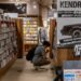 A woman sits quietly in a Tokyo listening bar, experiencing kissa culture through vinyl played on a hi-fi system