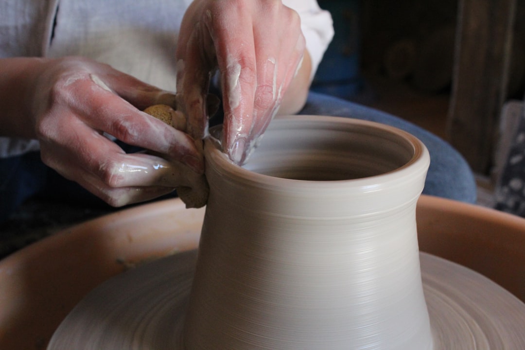 A woman shapes clay on a pottery wheel at one of Tokyo's open kiln studios during a summer session.