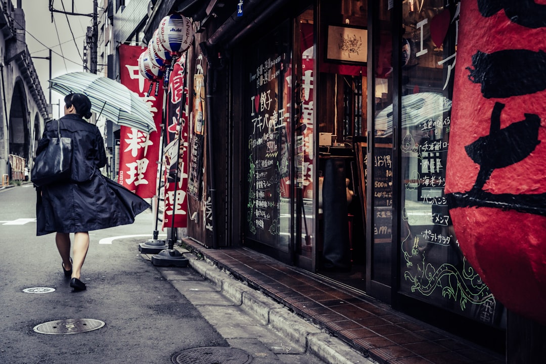 A professional woman in a breathable linen outfit walks through a Tokyo street