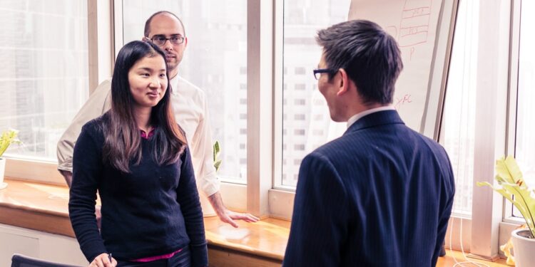 A foreign founder shaking hands with a Tokyo angel investor after a successful first meeting in a modern office