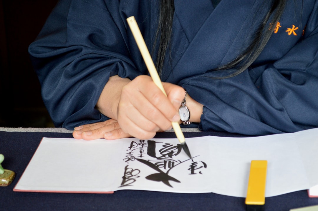 A girl practices calligraphy with a brush at a Tokyo craft workshop, during the Obon school-holiday week.