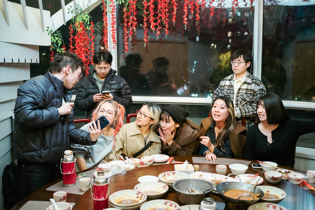 Friends sharing sashimi and yakitori plates at a gluten-free izakaya table in Tokyo