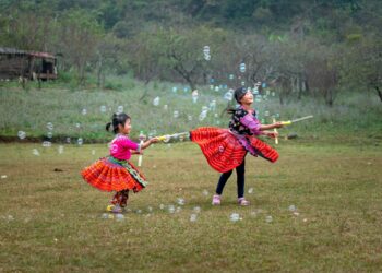 children in yukata join a bon odori circle during Obon week,