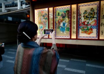 illustration prints displayed on a table at one of the popular art markets in Tokyo on a sunny weekend morning.