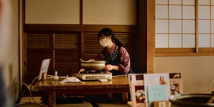 A woman cooking an izakaya menu in Tokyo while navigating a gluten-free izakaya dinner