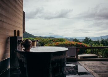 A woman resting in a private onsen suite, reflecting the serene standard of Tokyo wellness membership clubs