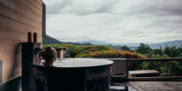 A woman resting in a private onsen suite, reflecting the serene standard of Tokyo wellness membership clubs