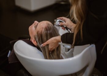 woman-scalp-massage-hair-salon-unsplash - TOKYOwebzine A woman relaxing during a scalp treatment at a Tokyo hair salon, eyes closed as a therapist works gently on her scalp