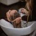 woman-scalp-massage-hair-salon-unsplash - TOKYOwebzine A woman relaxing during a scalp treatment at a Tokyo hair salon, eyes closed as a therapist works gently on her scalp