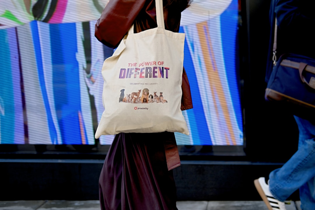 A woman using a knotted furoshiki wrapping as a reusable tote bag on a Tokyo street