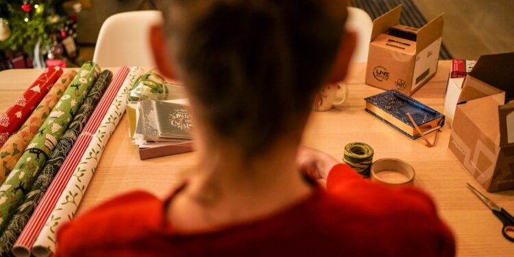 A woman in Tokyo carefully practising furoshiki wrapping with a patterned square textile